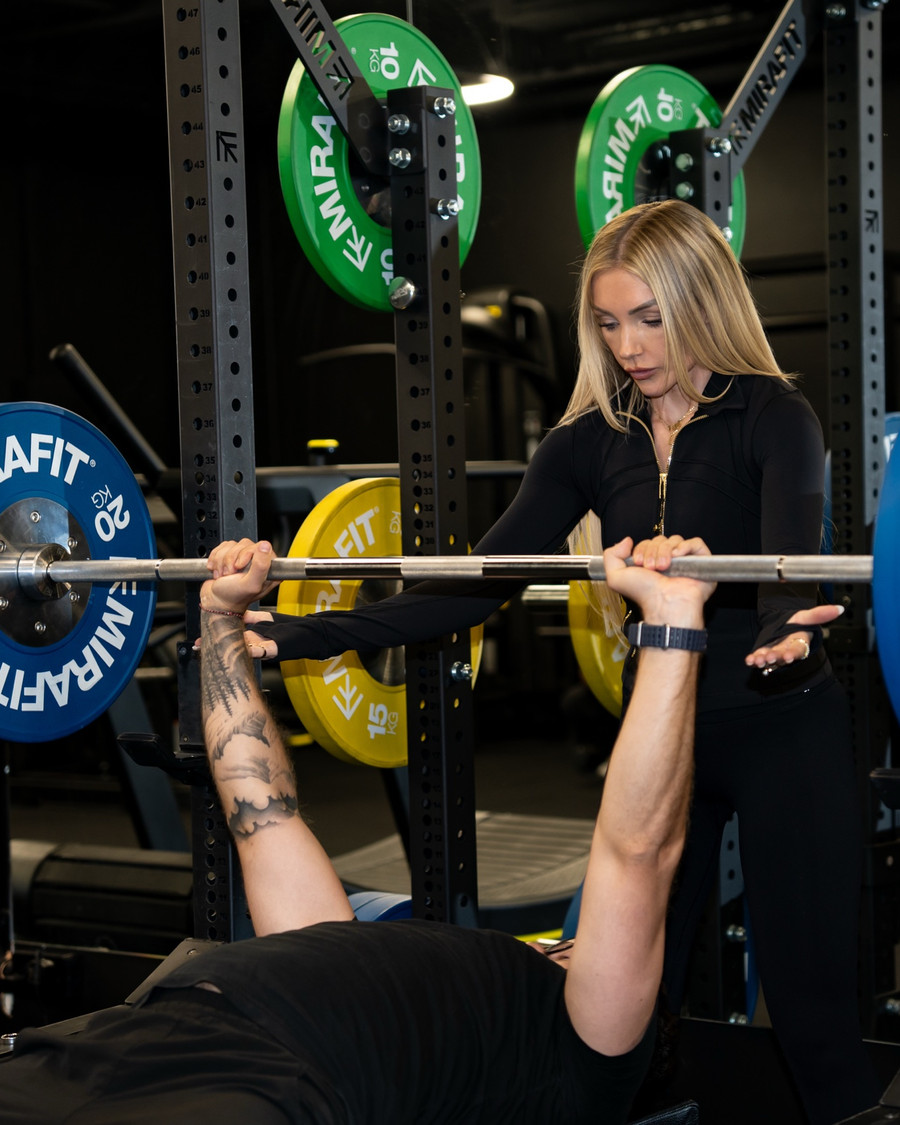 Coaching a client through a bench press