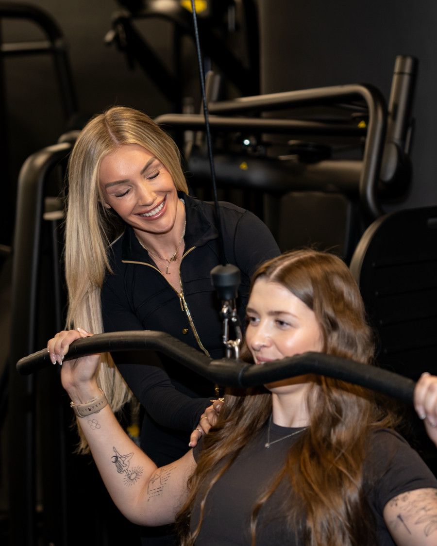 Coaching a client on a seated machine