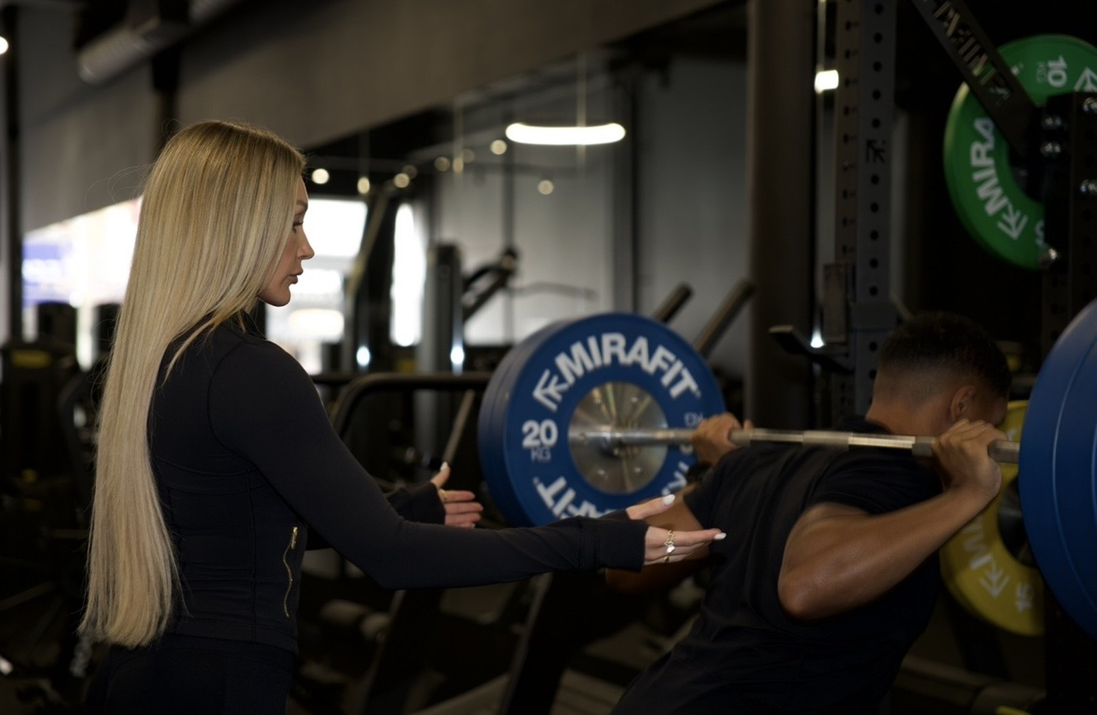 Coaching a client through a squat